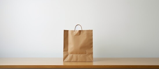 A solitary brown paper bag with empty space surrounding it set against a plain white background. Creative banner. Copyspace image - Powered by Adobe