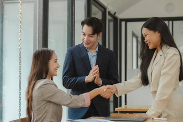 doing handshake in the office to make agreement, two companies are signing a contract to become a business partnership, handshake with client after make a deal for their project