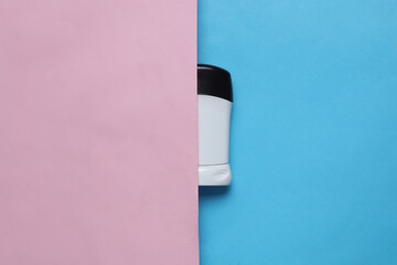 Antiperspirant tube on pink blue background. Sweat protection. Top view