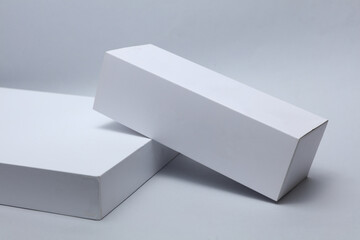 Different shapes of white cardboard boxes for presentation products on white background. Mockup for...