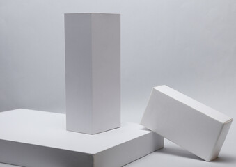 Different shapes of white cardboard boxes for presentation products on white background. Mockup for design.