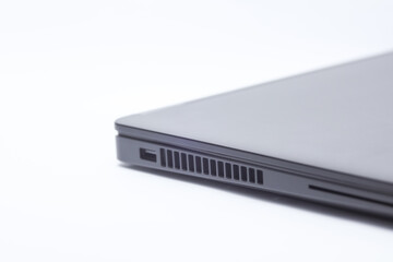 Closed black laptop closeup on white background