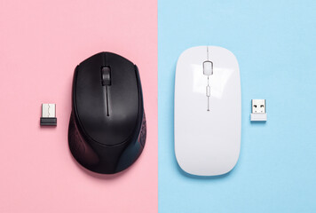 Two Wireless PC mouse with USB flash drives on pink blue  background. Top view. Creative layout