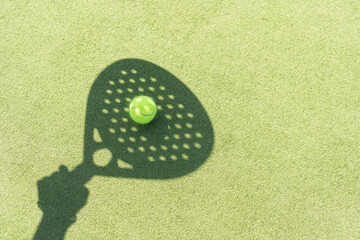Paddle tennis racket shadow on balls. - obrazy, fototapety, plakaty