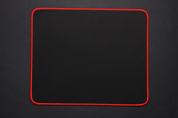 PC mouse pad on a black background. Top view