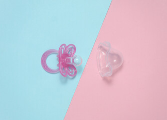 Baby pacifier on a blue pink background