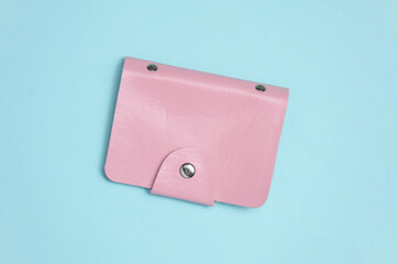 Pink Leather wallet business card holder on blue pastel background. Top view