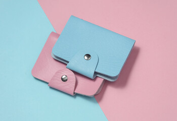 Leather wallets business card holders on blue pink pastel background. Top view