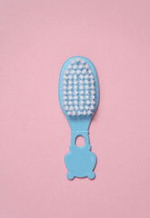 Hairbrush for newborn on a blue-pink background