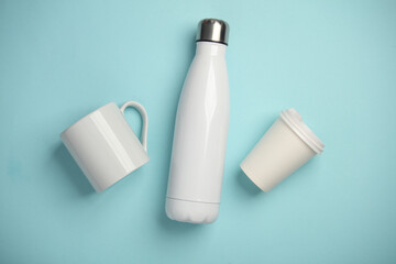 Mockup of white empty ceramic and cardboard cup and thermos bottle on blue pink blue background