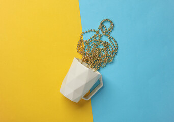 Cup with Christmas garland on yellow blue background