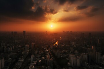 Fototapeta premium Dramatic sunset casting a warm glow over a sprawling city with skyscrapers and reflective river