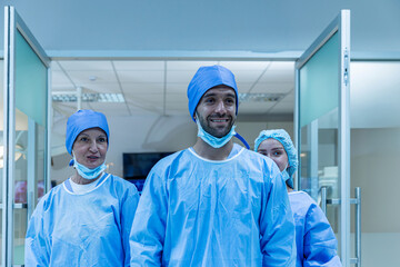 Surgeons team working with Monitoring of patient in surgical operating room. The doctors and nurses brainstorm power assisted surgery. A team of professional doctors perform surgery in a hospital