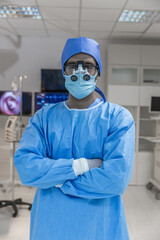 Fototapeta premium Portrait of doctor in glasses looking at camera while standing in operating room. Man surgeon in sterile gloves