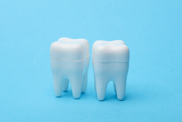 Plastic models of teeth on a blue background