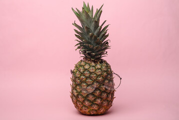 Pineapple in eyeglasses on a pink background