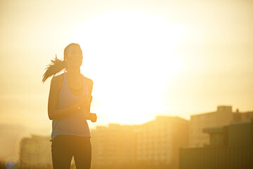 Woman, running and silhouette in sunrise for workout with mockup space on sky background in city....