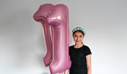 High resolution close up portrait of an 11 year old girl posing with her birthday balloons- Israel