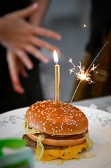 High resolution photo of an isolated birthday hamburger with a candle a small sparkler- Israel