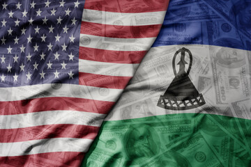 big waving colorful flag of united states of america and national flag of lesotho on the dollar...