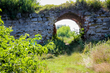 excursion to the ruins of an old castle in the grass, arches in an ancient wall, stonework,...
