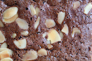Close up texture of brownies cake upper skin with almond topping