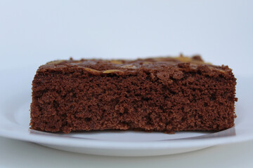 Brownies cake with almond topping, isolated on white background, side view