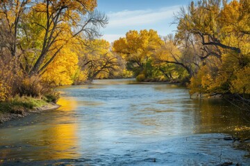 Obraz premium Idyllic Fall Landscape of Boise River on Greenbelt Trail in Park