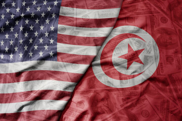 big waving colorful flag of united states of america and national flag of tunisia on the dollar...