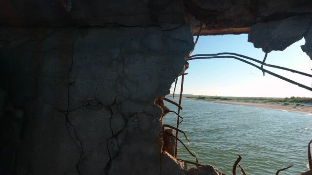 View of the Kinburn Spit through a hole in the side of an old abandoned barge that ran aground on the edge of the spit.