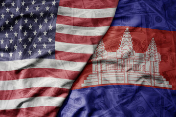 big waving colorful flag of united states of america and national flag of cambodia on the dollar...