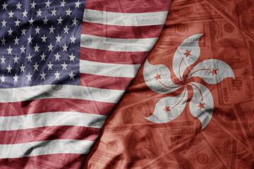 Obraz premium big waving colorful flag of united states of america and national flag of hong kong on the dollar money background. finance concept.