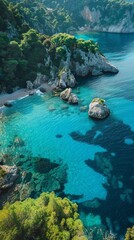 Aerial view of a secluded cove with crystal-clear turquoise water, fringed by lush greenery and dramatic cliffs