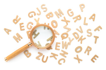 Magnifying glass and scattered English alphabets isolated on white background, glossary, find the...