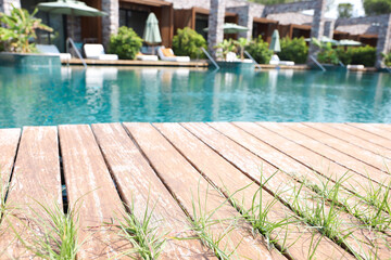 Outdoor swimming pool with wooden deck at resort