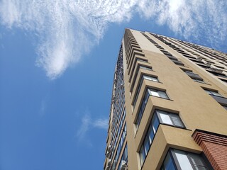 high-rise building against the blue sky. Low angle shooting