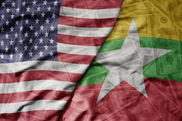 big waving colorful flag of united states of america and national flag of myanmar on the dollar...