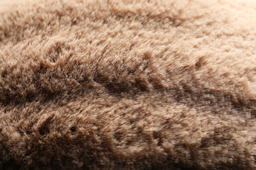 Texture of brown faux fur as background, closeup