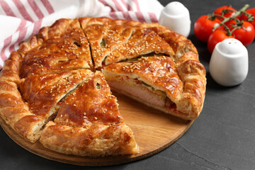 Cut delicious homemade pie on black table