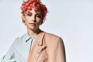 Extraordinary woman with fiery red hair stands confidently in a stylish jacket.