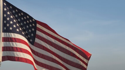 Concept of Veterans Day, Remembrance Day, Memorial Day, Remember and Honor, 4th of July, Independence Day, Veteran Day, Holiday, Celebration. American USA flag waving in sunset outdoor sky background