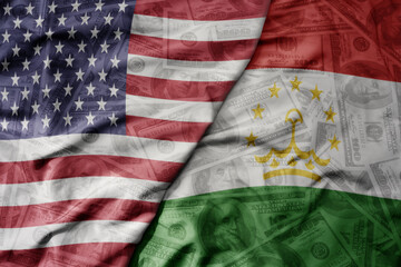 big waving colorful flag of united states of america and national flag of tajikistan on the dollar...
