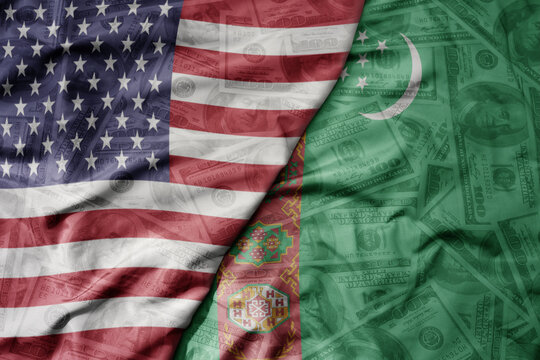 big waving colorful flag of united states of america and national flag of turkmenistan on the dollar money background. finance concept.