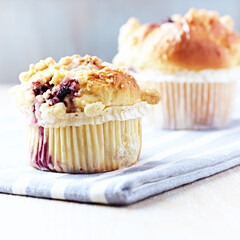 Muffins on bright wooden background. Close up. Copy space.