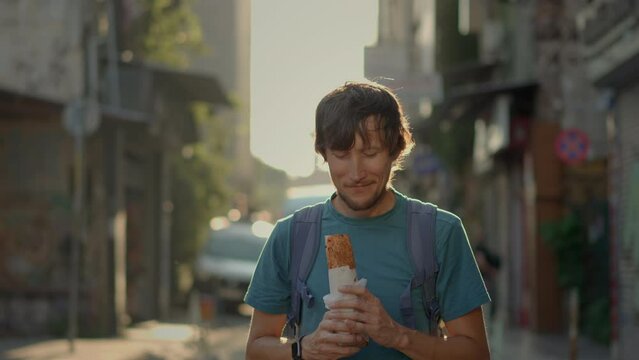 A delighted tourist savors the taste of Turkey, enjoying a freshly made balik ekmek wrap on the bustling streets of Istanbul.