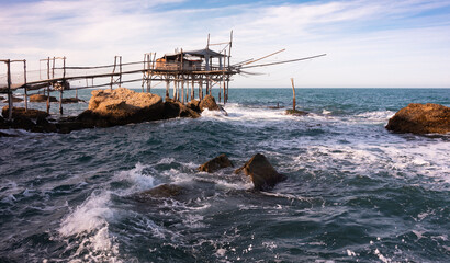 Traditional wooden fishing house with a net near sea coast