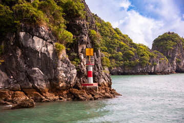 Rocky islands with lighthouse in sea bay in Vietnam