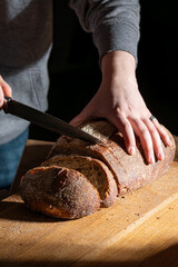 bread and clay vase on a wooden table.