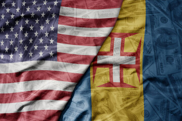 Obraz premium big waving colorful flag of united states of america and national flag of madeira on the dollar money background. finance concept.