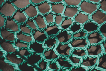 A net of green ropes